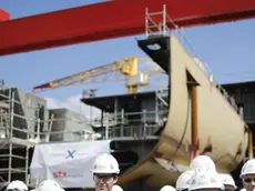 FILE - In this Wednesday, May 31, 2017 file photo, STX workers gather at the STX shipyard site in Saint-Nazaire, western France. The French and Italian governments are confident a deal will be announced Wednesday Sept.27 2017 allowing Italian shipbuilder Fincantieri to take control of a key French shipyard, ending a weeks-long disagreement between the countries. (Stephane Mahe/Pool Photo via AP, File)