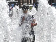 A child cools himself off in a fountain in De Ferrari square in Genoa, Italy, 24 July 2018. A heat wave continues to affect many areas of Italy, with temperatures rising to an intraday high of 35 degrees Celcius in Rome. ANSA/LUCA ZENNARO