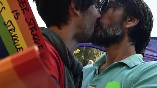 A gay couple kiss during the Pride Parade in Belgrade on September 28, 2014. Serbian gays and lesbians staged their first Belgrade Pride Parade in four years on Sunday, in what is seen as a test of the EU hopeful's commitment to protecting minority rights. With tight security, the march went off without incident, led off from the main government building, with hundreds of participants carrying rainbow-colored balloons and flags, and banners proclaiming "Pride", "Peace" and "Love". AFP PHOTO / ANDREJ ISAKOVIC