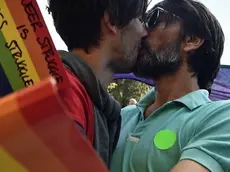 A gay couple kiss during the Pride Parade in Belgrade on September 28, 2014. Serbian gays and lesbians staged their first Belgrade Pride Parade in four years on Sunday, in what is seen as a test of the EU hopeful's commitment to protecting minority rights. With tight security, the march went off without incident, led off from the main government building, with hundreds of participants carrying rainbow-colored balloons and flags, and banners proclaiming "Pride", "Peace" and "Love". AFP PHOTO / ANDREJ ISAKOVIC