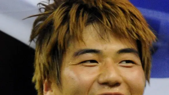 10 Aug 2012, Cardiff, Cardiff City and County, Wales, UK --- Sungyueng Ki celebrates holding the national flag of South Korea as he wins a bronze medal after his team defeated Japan 2-0 --- Image by © Matthew Ashton/AMA/Matthew Ashton/AMA/AMA/Corbis