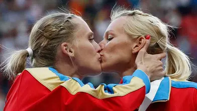 Gold medallists team Russia kiss and celebrate at the women's 4x400 metres relay victory ceremony during the IAAF World Athletics Championships at the Luzhniki stadium in Moscow August 17, 2013. From left: Yulia Gushchina, Kseniya Ryzhova, Tatyana Firova and Antonina Krivoshapka. REUTERS/Grigory Dukor (RUSSIA - Tags: SPORT ATHLETICS) - RTX12P3H