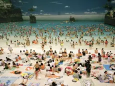 Japan. Miyazaki. The Artificial beach inside the Ocean Dome. From 'Small World'. 1996. Images for use only in connection with direct publicity for the exhibition "Life's a beach" by Martin Parr presented at Museo Revoltella, Trieste, Italy from October 27th, 2019 to January 6th, 2020. These images are for one time non-exclusive use only and must not be electronically stored in any media asset retrieval database · Images must be credited and captioned as outlined by Magnum Photos · Images must not be reproduced online at more than 1000 pixels without permission from Magnum Photos · Images must not be overlaid with text, cropped or altered in any way without permission from Magnum Photos.