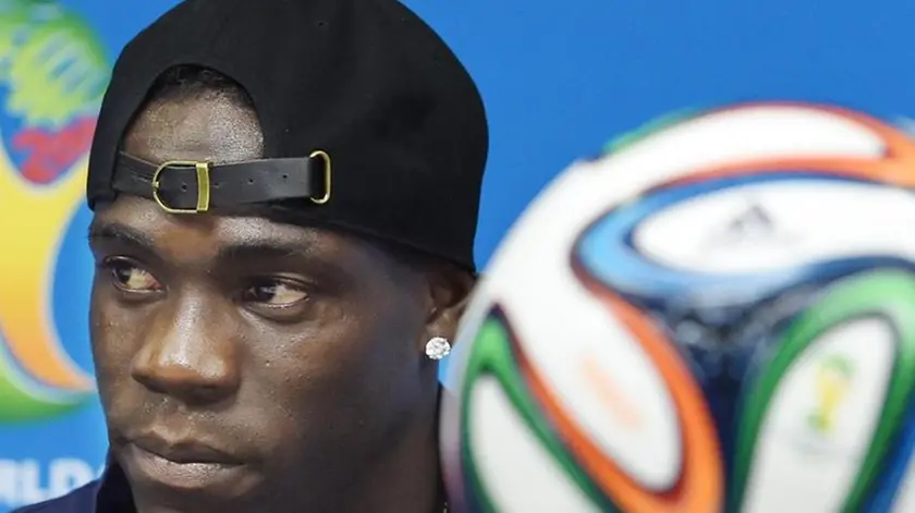Italy's forward Mario Balotelli during a press conference at the Arena Pernambuco in Recife, Brazil, 19 June 2014. (RESTRICTIONS APPLY: Editorial Use Only, not used in association with any commercial entity - Images must not be used in any form of alert service or push service of any kind including via mobile alert services, downloads to mobile devices or MMS messaging - Images must appear as still images and must not emulate match action video footage - No alteration is made to, and no text or image is superimposed over, any published image which: (a) intentionally obscures or removes a sponsor identification image; or (b) adds or overlays the commercial identification of any third party which is not officially associated with the FIFA World Cup) aNSA/DANIEL DAL ZENNARO
