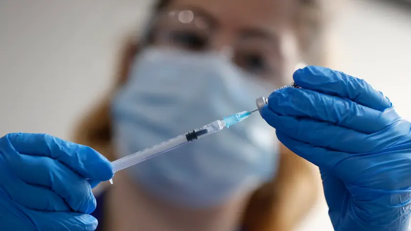 A nurse prepares a shot of the Pfizer-BioNTech COVID-19 vaccine at Guy's Hospital in London, Tuesday, Dec. 8, 2020, as the U.K. health authorities rolled out a national mass vaccination program. U.K. regulators said Wednesday Dec. 9, 2020, that people who have a “significant history’’ of allergic reactions shouldn’t receive the new Pfizer/BioNTech vaccine while they investigate two adverse reactions that occurred on the first day of the country’s mass vaccination program. (AP Photo/Frank Augstein, Pool)