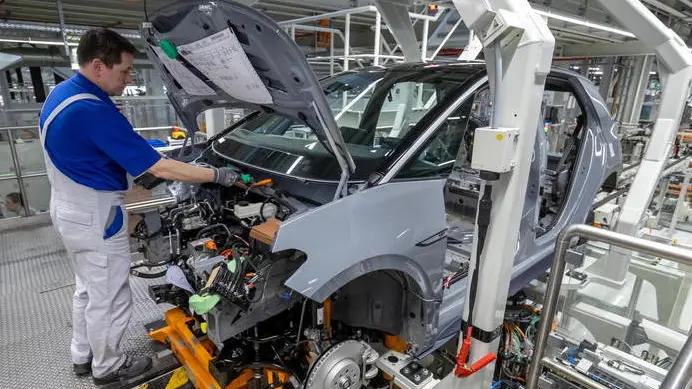 epa08247697 A Volkswagen employee works on a Volkswagen ID.3 car in the assembly line during the production of the electric car at the Volkswagen (VW) vehicle factory in Zwickau, Germany, 25 February 2020. The Volkswagen annual press conference will be held on 17 March 2020 in Wolfsburg. EPA/UWE MEINHOLD