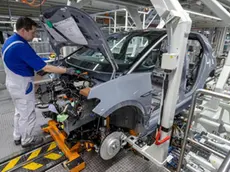 epa08247697 A Volkswagen employee works on a Volkswagen ID.3 car in the assembly line during the production of the electric car at the Volkswagen (VW) vehicle factory in Zwickau, Germany, 25 February 2020. The Volkswagen annual press conference will be held on 17 March 2020 in Wolfsburg. EPA/UWE MEINHOLD