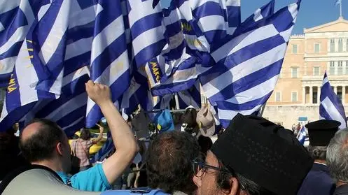 epa06856401 Protesters, opposing the name dispute agreement between Greece and FYROM, hold greek flags and shout slogans in front of the Parliament, during a rally in Athens, Greece, 01 July 2018. The historic agreement resolving the decades-long name dispute between Greece and Former Yugoslav Republic of Macedonia was signed on 17 June 2018. EPA/ALEXANDROS BELTES