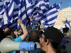 epa06856401 Protesters, opposing the name dispute agreement between Greece and FYROM, hold greek flags and shout slogans in front of the Parliament, during a rally in Athens, Greece, 01 July 2018. The historic agreement resolving the decades-long name dispute between Greece and Former Yugoslav Republic of Macedonia was signed on 17 June 2018. EPA/ALEXANDROS BELTES