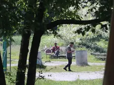 In alto alcuni migranti già ospitati a Campo Sacro, sopra il cartello della frazione e dell’ex Ostello Foto Lasorte