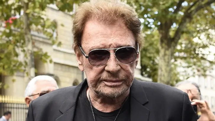 (FILES) This file photo taken on September 1, 2017 shows French singer Johnny Hallyday at the Saint-Sulpice church to attend a funeral in Paris. Johnny Hallyday, who has been battling lung cancer for several months, has been hospitalized in Paris since November 13, 2017, according to reports in French weekly Voici on November 17, 2017. / AFP PHOTO / BERTRAND GUAY