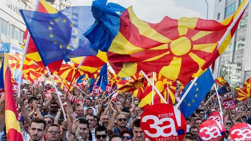 People wave Macedonian and Europan flags as they attend a campaign rally for the "yes" ahead of a referendum on wether to change the country's name to "Republic of Northern Macedonia", in Skopje on September 16, 2018. - The referendum is scheduled for September 30 and follows an agreement with neighboring Greece to end a decades-long dispute over the countrys name. If voters back the new name, Greece has agreed to stop blocking Macedonia from joining NATO. (Photo by Robert ATANASOVSKI / AFP) (Photo credit should read ROBERT ATANASOVSKI/AFP/Getty Images)