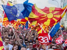 People wave Macedonian and Europan flags as they attend a campaign rally for the "yes" ahead of a referendum on wether to change the country's name to "Republic of Northern Macedonia", in Skopje on September 16, 2018. - The referendum is scheduled for September 30 and follows an agreement with neighboring Greece to end a decades-long dispute over the countrys name. If voters back the new name, Greece has agreed to stop blocking Macedonia from joining NATO. (Photo by Robert ATANASOVSKI / AFP) (Photo credit should read ROBERT ATANASOVSKI/AFP/Getty Images)