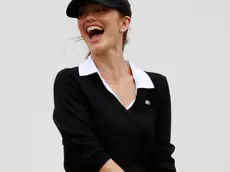 American actress Minka Kelly laughs after missing to hit the ball to tee off during the pro-am games at the World Celebrity Pro-Am golf tournament in Haikou, in southern China's island province Hainan on Friday, Oct. 19, 2012. (AP Photo/Eugene Hoshiko)