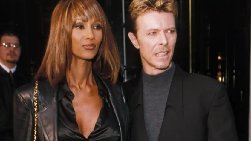 IMAN & DAVID BOWIE At The Q Awards, 7th November 1 995 full length black suit leather trousera red boots satin shirt goatie beard short hair couple wife husband www.capitalpictures.com sales@capitalpictures.com ©Capital Pictures