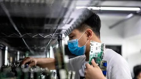 epa08296711 A man works in the VDWALL factory in Shenzhen, Guangdong province, China, 13 March 2020 (issued 16 March 2020). China's value-added industrial output, an important economic indicator, fell 13.5 percent year-on-year in the first two months of 2020 as the coronavirus outbreak hurt activities, according to a report issued by the National Bureau of Statistics on 16 March 2020. VDWALL is a high-tech enterprise specializing in developing and manufacturing video processing equipment for LED displays. EPA/ALEX PLAVEVSKI