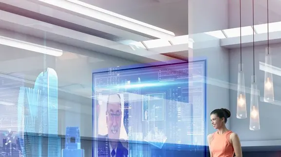 Caucasian businesswoman using hologram computer screen --- Image by © Colin Anderson/Blend Images/Corbis