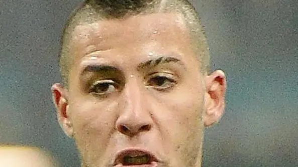 AC Milan Ghanaian midfielder Sulley Ali Muntari (L) vies for the ball with Inter Milan midfielder Saphir Taider during their Serie A soccer match at the Giuseppe Meazza stadium in Milan, Italy, 22 December 2013. ANSA/DANIEL DAL ZENNARO