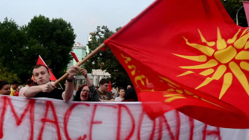 epa06805599 Protestors wave flags and shout slogans during an anti-government protest in front of the Parliament building in Skopje, The Former Yugoslav Republic of Macedonia (FYROM), 13 June 2018. Demonstrators protested the government's politics as well as against a compromise solution in Macedonia's dispute with Greece over the country's name. EPA/NAKE BATEV