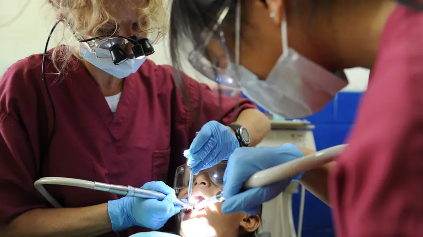 110718-N-QD416-148 ACAJUTLA, El Salvador (July 18, 2011) Dr. Braille Watson and Mindy Li, volunteers from the University of California San Diego Pre-dental Society, perform a restorative procedure on a patient's teeth during a Continuing Promise 2011 community service medical event at the Instituto Nacional Acajutla. Continuing Promise is a five-month humanitarian assistance mission to the Caribbean, Central and South America. (U.S. Navy photo by Mass Communication Specialist 1st Class Brian A. Goyak/Released)