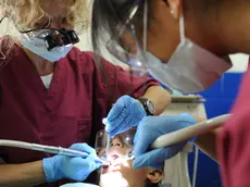 110718-N-QD416-148 ACAJUTLA, El Salvador (July 18, 2011) Dr. Braille Watson and Mindy Li, volunteers from the University of California San Diego Pre-dental Society, perform a restorative procedure on a patient's teeth during a Continuing Promise 2011 community service medical event at the Instituto Nacional Acajutla. Continuing Promise is a five-month humanitarian assistance mission to the Caribbean, Central and South America. (U.S. Navy photo by Mass Communication Specialist 1st Class Brian A. Goyak/Released)