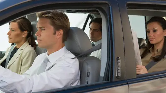 Business people car pooling --- Image by © Tetra Images/Corbis