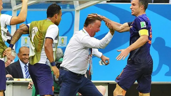 epa04254644 Dutch player Robin van Persie (R)celebrates with coach Louis van Gaal after scoring the 1-1 goal during the FIFA World Cup 2014 group B preliminary round match between Spain and the Netherlands at the Arena Fonte Nova in Salvador, Brazil, 13 June 2014. (RESTRICTIONS APPLY: Editorial Use Only, not used in association with any commercial entity - Images must not be used in any form of alert service or push service of any kind including via mobile alert services, downloads to mobile devices or MMS messaging - Images must appear as still images and must not emulate match action video footage - No alteration is made to, and no text or image is superimposed over, any published image which: (a) intentionally obscures or removes a sponsor identification image; or (b) adds or overlays the commercial identification of any third party which is not officially associated with the FIFA World Cup) EPA/KOEN VAN WEEL EDITORIAL USE ONLY