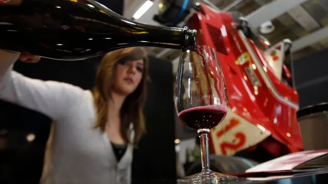 A woman pours a glass of Lambrusco red sparkling wine on the opening day of the 44th edition of the annual International Wine and Spirits Exhibition "Vinitaly", in Verona, northern Italy, Thursday, April 8, 2010. The wine exhibition runs until April 12, in the city made famous by the tale of Romeo and Juliet. (AP Photo/Luca Bruno)