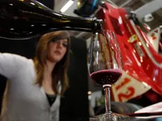 A woman pours a glass of Lambrusco red sparkling wine on the opening day of the 44th edition of the annual International Wine and Spirits Exhibition "Vinitaly", in Verona, northern Italy, Thursday, April 8, 2010. The wine exhibition runs until April 12, in the city made famous by the tale of Romeo and Juliet. (AP Photo/Luca Bruno)