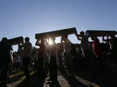 epa04841345 Bosnian muslim men carry coffins with remains of relatives at the Potocari Memorial Center in Srebrenica, Bosnia and Herzegovina, 10 July 2015. A total of 136 newly-identified Bosnian Muslims will be buried on 11 July 2015 as part of a memorial ceremony to mark the 18th anniversary of the Srebrenica massacre. July 2015 marks the 20-year anniversary of the Srebrenica Massacre that saw more than 8,000 Bosnians men and boys killed by Bosnian Serb forces during the Bosnian war. On 08 July Russia vetoed a United Nations Security Council resolution that would have labeled as genocide the 1995 massacre of Muslims in Srebrenica by ethnic Serbs. EPA/VALDRIN XHEMAJ