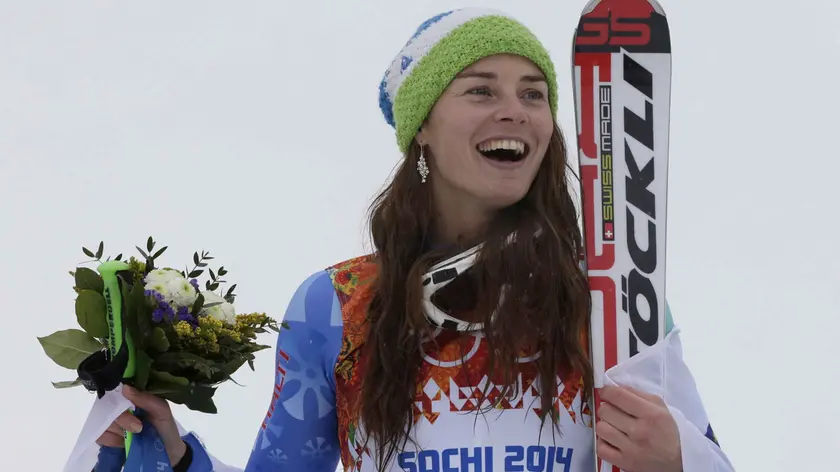 Women's giant slalom gold medal winner Tina Maze of Slovenia smiles on the podium during a flower ceremony at the Sochi 2014 Winter Olympics, Tuesday, Feb. 18, 2014, in Krasnaya Polyana, Russia. (AP Photo/Gero Breloer)
