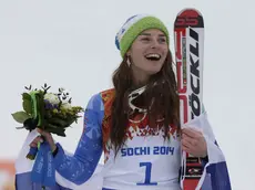 Women's giant slalom gold medal winner Tina Maze of Slovenia smiles on the podium during a flower ceremony at the Sochi 2014 Winter Olympics, Tuesday, Feb. 18, 2014, in Krasnaya Polyana, Russia. (AP Photo/Gero Breloer)