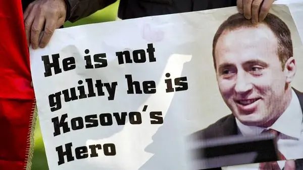 epa03490152 A supporter of the former commander of the Kosovo Liberation Army Ramush Haradinaj with a sign in front of the International Criminal Tribunal for the former Yugoslavia at the Hague, Netherlands, 29 November 2012. Media reports on 29 November 2012 state that the UN war crimes tribunal has cleared Ramush Haradinaj after a retrial in The Hague. EPA/KOEN VAN WEEL / POOL