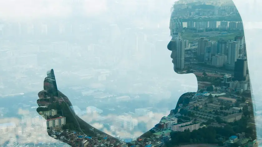 02 Jul 2013, Seoul, South Korea --- Girl using smartphone and city, double exposure. --- Image by © Jasper James/Corbis