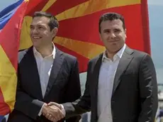 epa06815071 Greek Prime Minister Alexis Tsipras (L) and FYROM Prime Minister Zoran Zaev (R) shake hands after their arrival on Macedonian side of the Lake Prespa, near Otesevo, the Former Yugoslav Republic of Macedonia (FYROM), 17 June 2018. Prime Ministers from Greece and Macedonia meet in the Prespes lake district, that borders both countries, and sign an agreement aimed at ending a decades-long dispute between their countries. The agreement shall lead to the renaming of Greece's northern neighbour, as well as its EU and NATO entry. EPA/NAKE BATEV