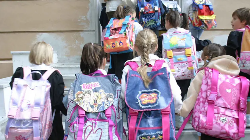 20040607 - ROMA - CRO : SCUOLA: ESAME QUINTA IN PENSIONE, 500MILA FARANNO ULTIMO. Un' immagine di archivio mostra bambini delle elementari all' ingresso della scuola. Sono circa mezzo milione i bambini alla prese quest'anno con il loro primo esame, quello di quinta elementare. Il loro primo, ma l'ultimo del genere. La riforma della scuola targata Moratti, infatti, manda in pensione questo appuntamento che e' stato tappa del percorso scolastico per generazioni di studenti. Rimarra' in vigore soltanto per l'anno scolastico in corso coinvolgendo 527.697 bambini. LUCA ZENNARO-ARCHIVIO / ANSA / PAL