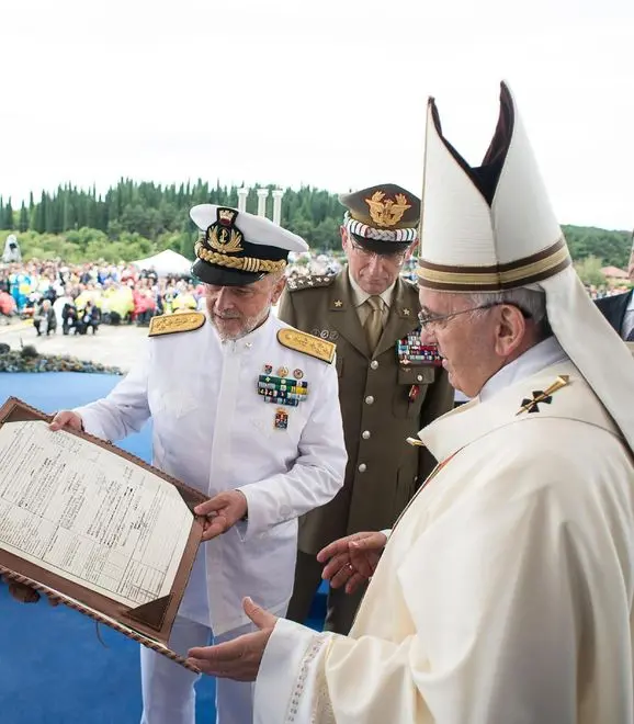 13 Sep 2014 --- Pope Francis receives the matricula sheet of his grandfather Giovanni Carlo Bergoglio, that fought in World War I, Redipuglia, 13 September 2014. Pope Francis has commemorate the centennial of the beginning of World War I with a pilgrimage to the Italian war memorial in the village of Fontano Redipuglia, which lies close to the Slovenian border in Italy's north-eastern Friuli Venezia Giulia region. ANSA/ L'OSSERVATORE ROMANO - PRESS OFFICE ++NO SALES EDITORIAL USE ONLY++ --- Image by © ANSA/Corbis