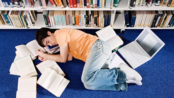 Student Sleeping in Library --- Image by © Image Source/Corbis