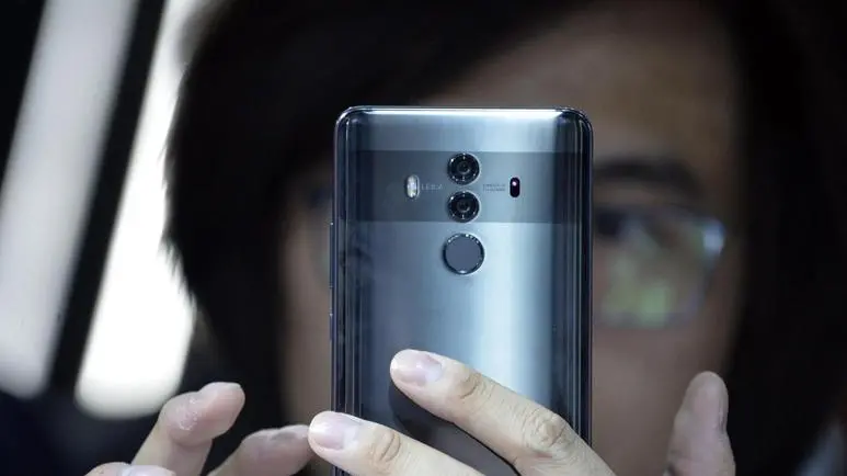 An attendee tries out the new Huawei Mate 10 Pro during the official launch event for the Huawei Mate 10 smartphone series in Munich, southern Germany, 16 October 2017. The chinese manufacturer's new offering is aimed at the luxury market. EPA/PHILIPP GUELLAND