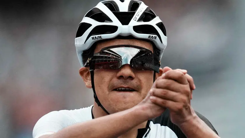 Richard Carapaz of Ecuador celebrates after winning the gold medal during the men's cycling road race at the 2020 Summer Olympics, Saturday, July 24, 2021, in Oyama, Japan. (AP Photo/Thibault Camus)
