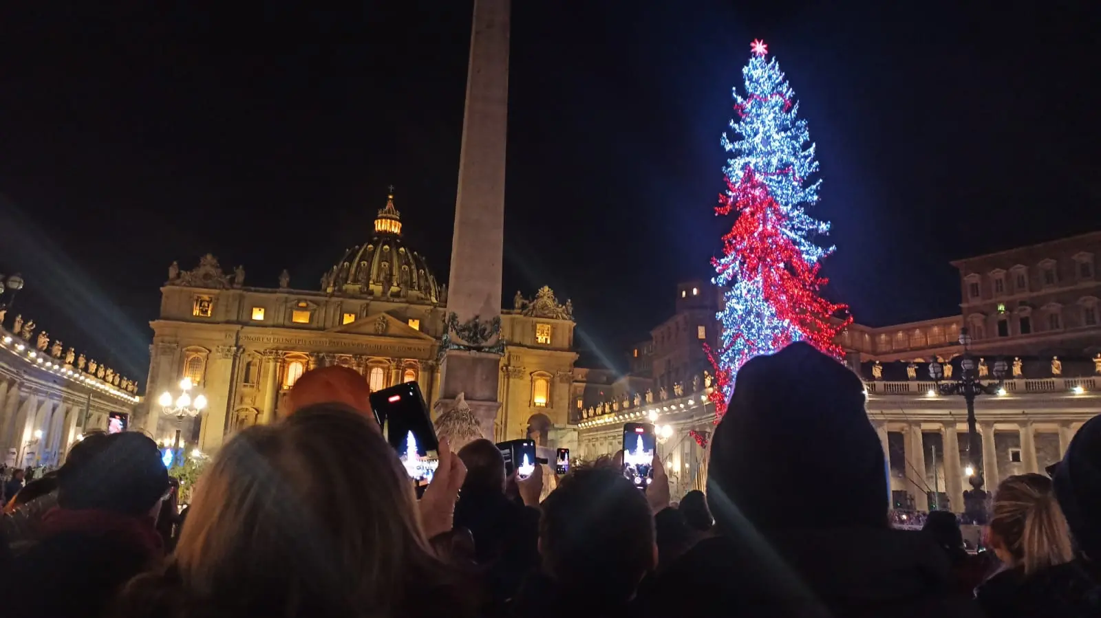 Il momento più atteso con lo svelamento del presepe e l'accensione dell'albero di Natale è arrivato, mentre le bande suonano White Christmas. Tutti i cellulari accesi riprendono. Arriva un "oooh" e un applauso dalla folla