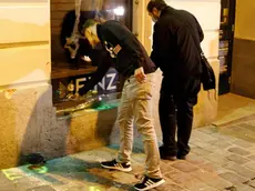 epa08795813 Two men put flowers at a crime sceen after multiple shootings in the first district of Vienna, Austria, 03 November 2020. According to recent reports, at least four persons are reported to have died and many are seriously injured in what officials treat as a terror attack which took place in the evening of 02 November. EPA/FLORIAN WIESER