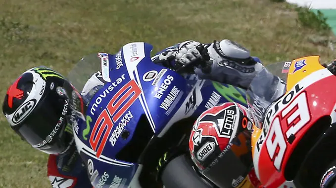 Honda rider Marc Marquez, right, of Spain, and Yamaha rider Jorge Lorenzo, of Spain, challenge for first place during the Italian Moto GP, at the Mugello race circuit, in Scarperia, Italy, Sunday, June 1, 2014. Marc Marquez won the Italian Grand Prix on Sunday with a pass at the start of the final lap to extend his perfect start to the MotoGP season. With his sixth consecutive victory, Marquez became the first rider since Valentino Rossi won seven straight in 2002 to take six or more successive races. (AP Photo/Antonio Calanni)