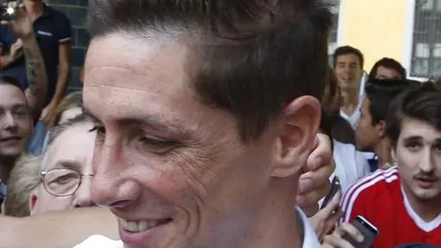 Spanish striker Fernando Torres, center, is surrounded by AC Milan supporter as he arrives at the "Madonnina Clinic' for a medical visit in Milan, Italy, Saturday, Aug. 30, 2014. Chelsea has agreed terms with AC Milan for Torres to join the Serie A club in a two-year loan deal. The Premier League club and Milan announced the agreement on their websites Friday, adding that "the move is now subject to Fernando agreeing personal terms with AC Milan and passing a medical examination." (AP Photo/Luca Bruno)