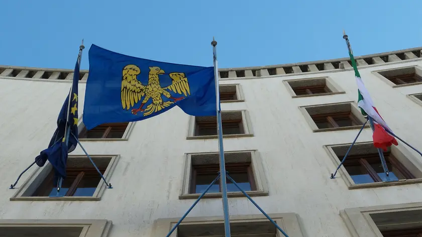 La bandiera del Friuli con l'aquila araldica sventola sul palazzo del Consiglio regionale