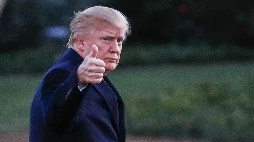 epa05832223 US President Donald J. Trump gestures after disembarking Marine One walking on the South Lawn towards the Oval Office of the White House in Washington, DC, USA, 05 March 2017. Trump returned to Washington from a weekend at his Palm Beach. Florida, Mar-a-Lago club. EPA/ERIK S. LESSER