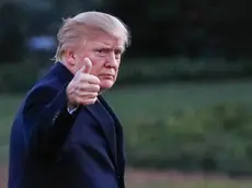 epa05832223 US President Donald J. Trump gestures after disembarking Marine One walking on the South Lawn towards the Oval Office of the White House in Washington, DC, USA, 05 March 2017. Trump returned to Washington from a weekend at his Palm Beach. Florida, Mar-a-Lago club. EPA/ERIK S. LESSER