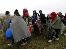 Refugees walk from Croatia to Slovenia through a green field near Rigonce village at the Slovenian border, 25 October 2015. .ANSA/ANTONIO BAT