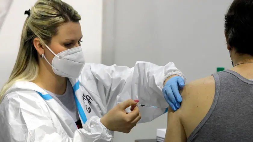 epa08979759 A medical worker applies a dose of Russia's Sputnik V Gam-COVID-Vac vaccine against the COVID-19 to a patient during the vaccination at Belgrade Fair makeshift vaccination center in Belgrade, Serbia, 01 February 2021. Serbia began its COVID-19 vaccination campaign of elderly and medical workers on 24 December 2020 moving to members general population. EPA/MARKO DJOKOVIC