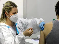 epa08979759 A medical worker applies a dose of Russia's Sputnik V Gam-COVID-Vac vaccine against the COVID-19 to a patient during the vaccination at Belgrade Fair makeshift vaccination center in Belgrade, Serbia, 01 February 2021. Serbia began its COVID-19 vaccination campaign of elderly and medical workers on 24 December 2020 moving to members general population. EPA/MARKO DJOKOVIC